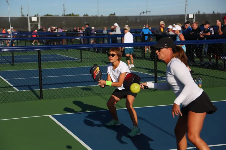outdoor pickleball courts - two women getting ready to play