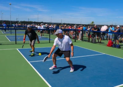 outdoor pickleball courts - man taking a low shot