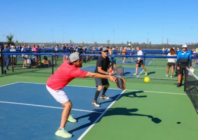 outdoor pickleball courts - man taking a low shot