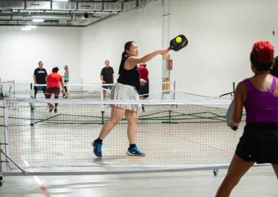 bower place indoor pickleball courts - woman taking a high shot
